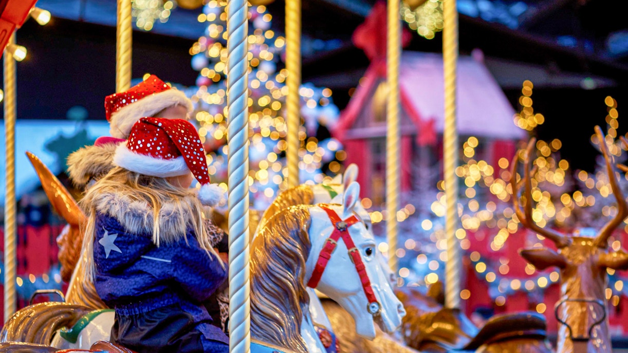 Children on a carousel at Tivoli Gardens during Christmas.