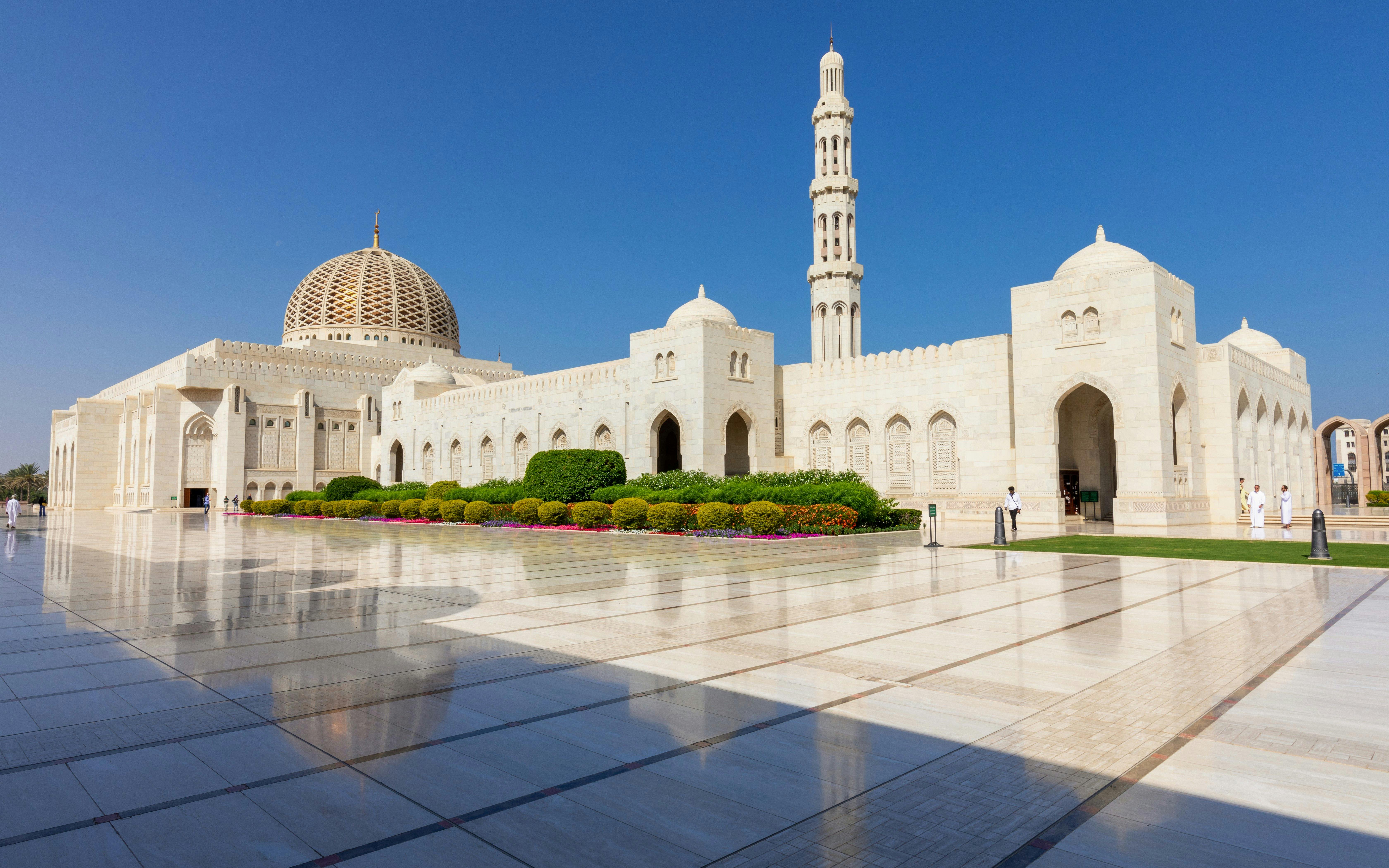 Sultan Qaboos Grand Mosque exterior with dome and minaret, Muscat, Oman.