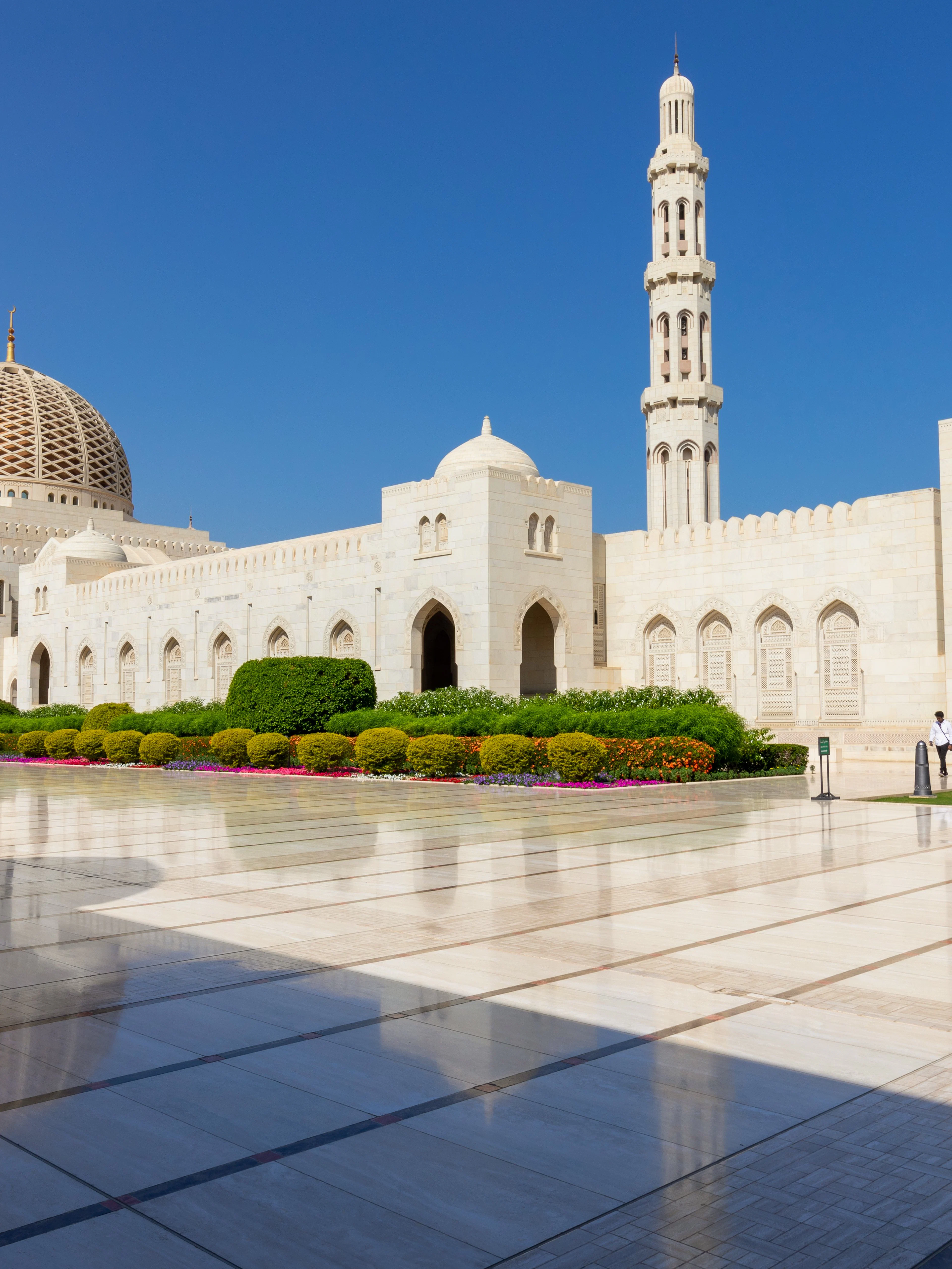 Sultan Qaboos Grand Mosque exterior with dome and minaret, Muscat, Oman.
