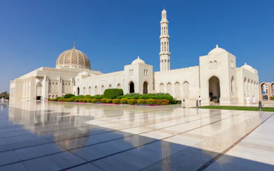 Sultan Qaboos Grand Mosque exterior with dome and minaret, Muscat, Oman.