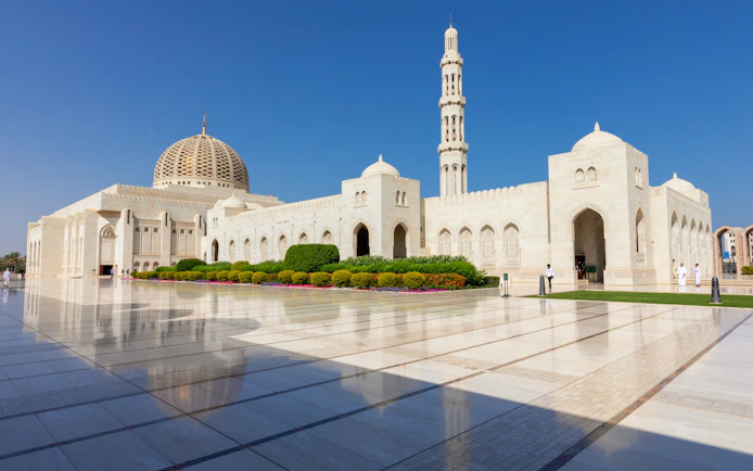 Sultan Qaboos Grand Mosque exterior with dome and minaret, Muscat, Oman.