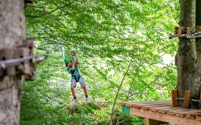 Child ziplining through trees at Ropes Park Interlaken.