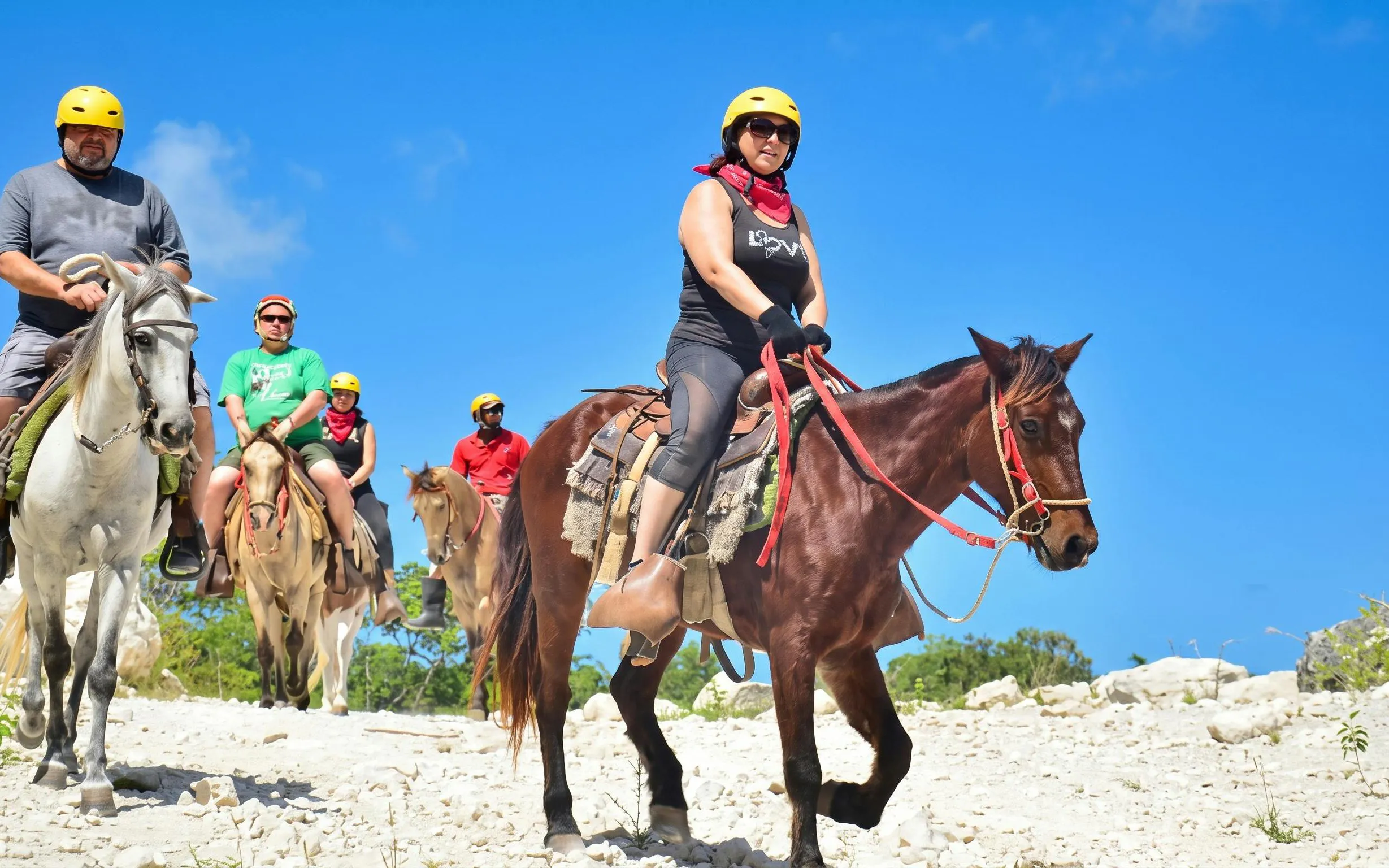 Group horseback riding on a trail at Macao Beach, Dominican Republic.