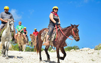 Group horseback riding on a trail at Macao Beach, Dominican Republic.