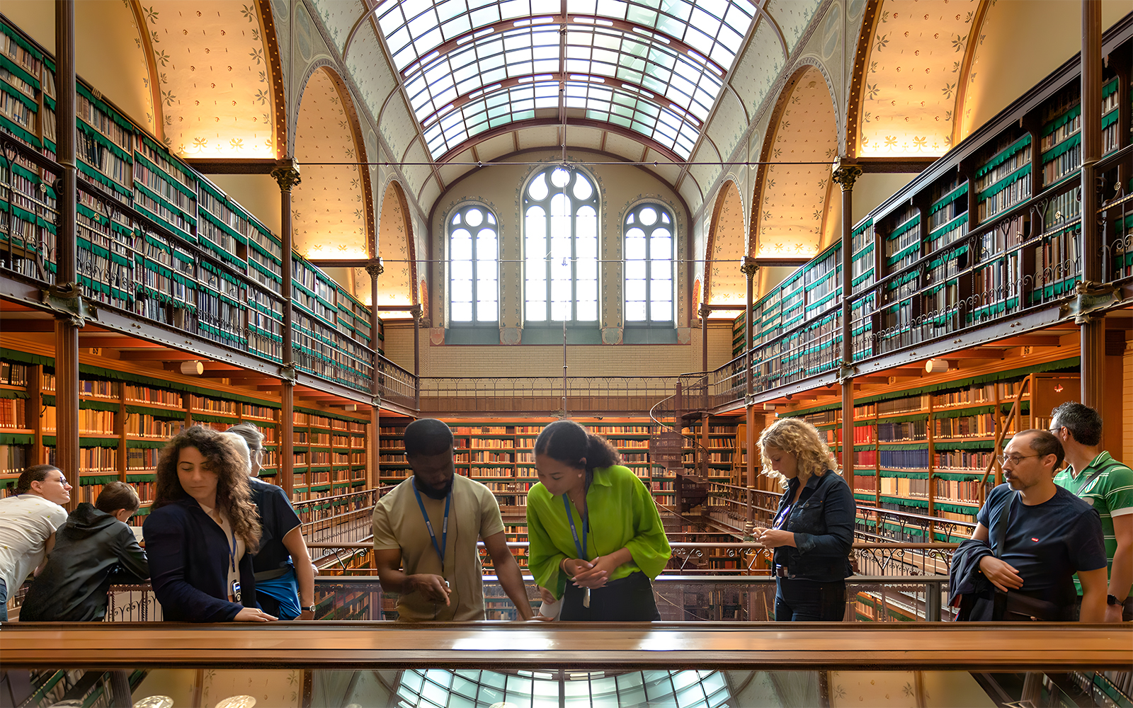 Visitors exploring the library in the Rijksmuseum during a guided tour in Amsterdam.