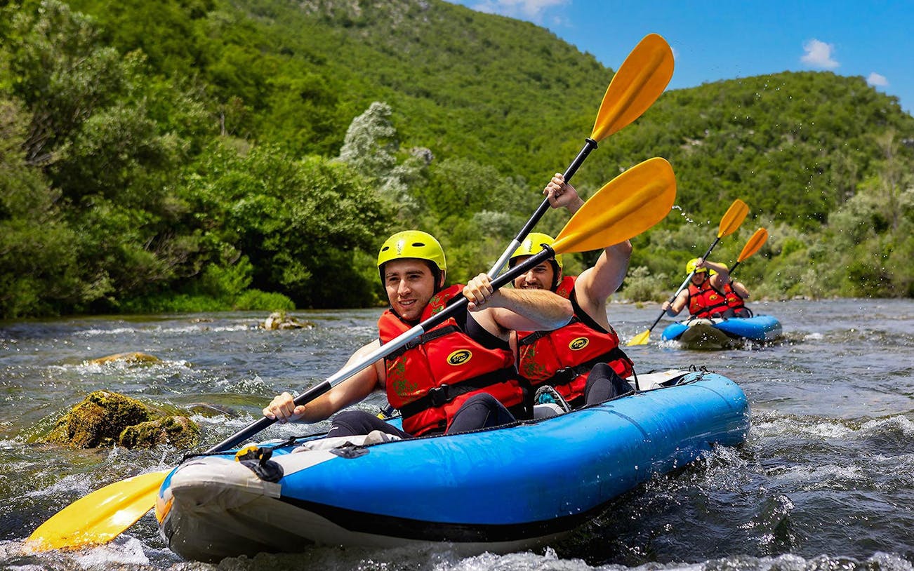 Rafting group navigating river near Split, Croatia, during Rapid Rafting tour.