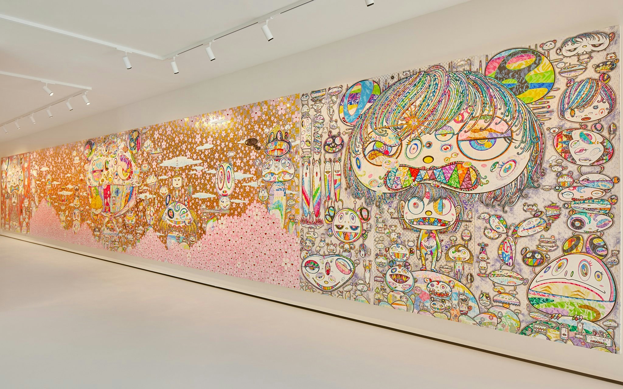 Colorful mural by Yayoi Kusama at Moco Museum London featuring abstract faces and patterns.