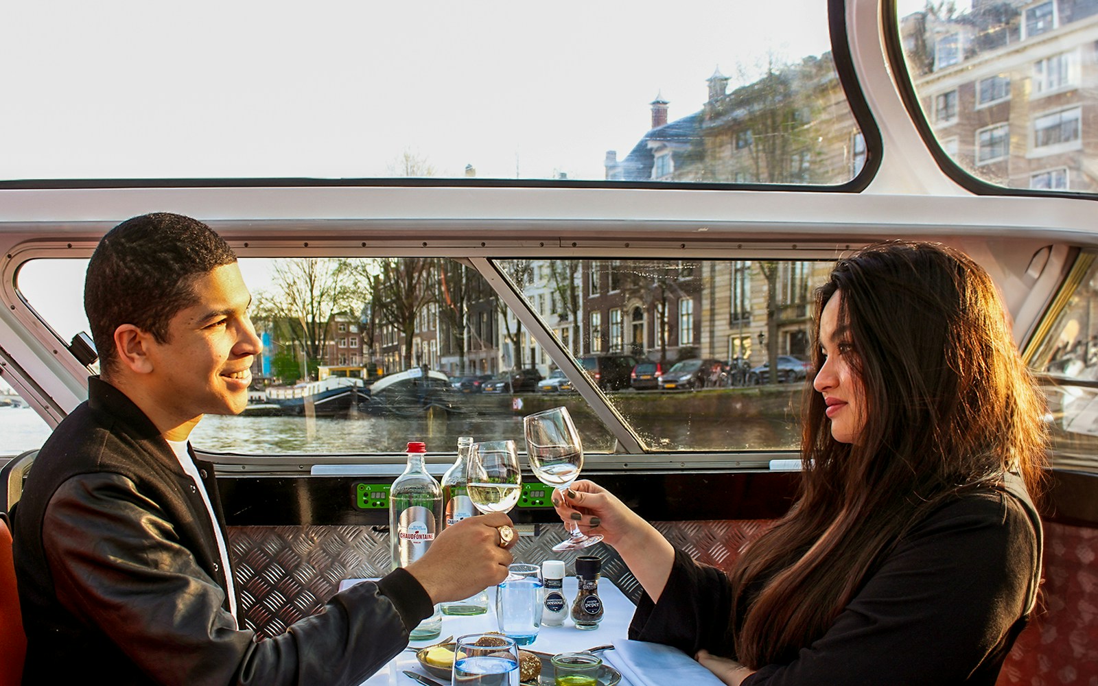 Guests enjoying wine on Amsterdam dinner cruise with four-course menu