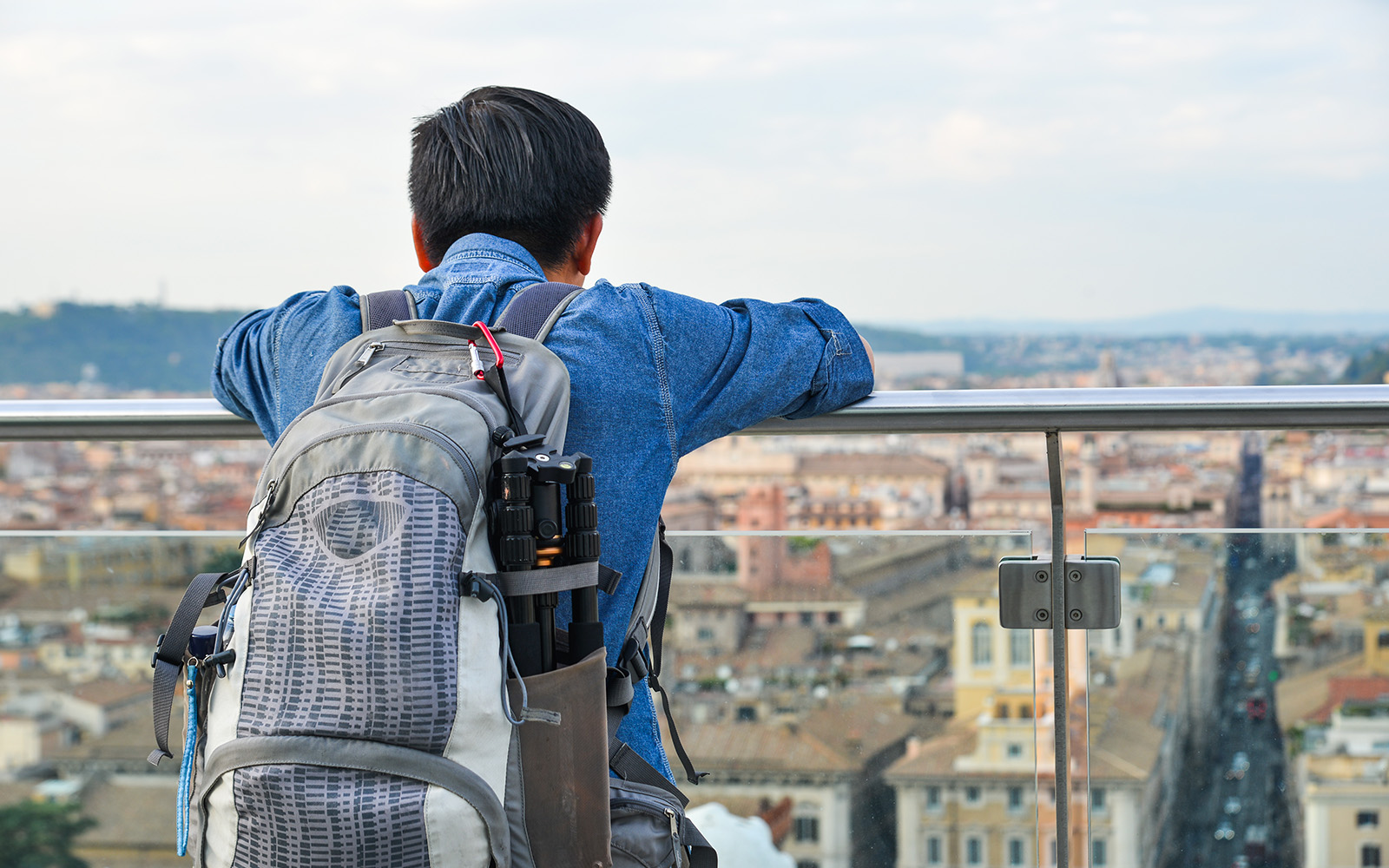 Traveler overlooking Rome from Altare della Patria viewpoint.