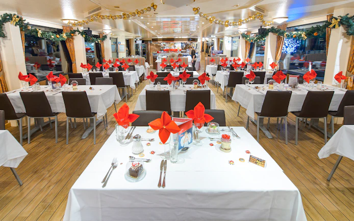 Dining area on Vienna Danube cruise with tables set for guests.