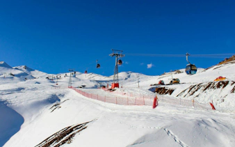 Ski lifts and snowy slopes at Valle Nevado ski resort in the Andes Mountains, Chile.