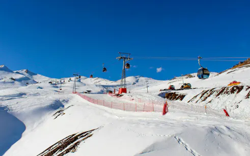 Ski lifts and snowy slopes at Valle Nevado ski resort in the Andes Mountains, Chile.