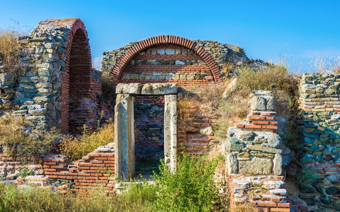 Ancient ruins at Histria, Dobrogea, showcasing stone and brick arches.