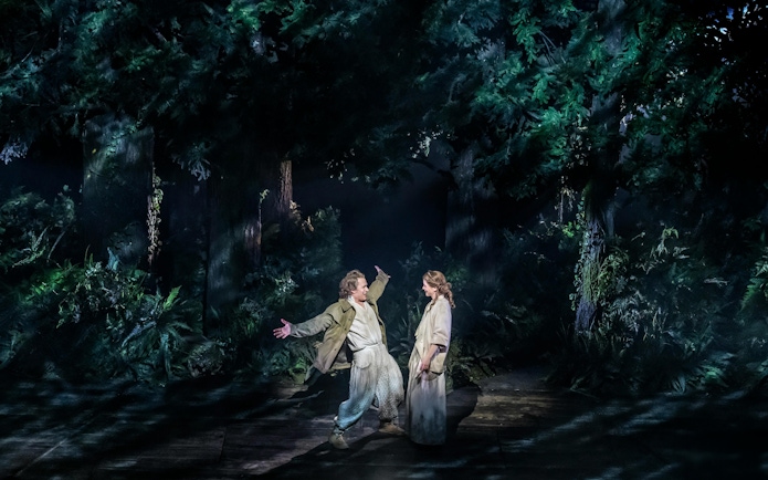 Actors performing in a forest scene from "Into The Woods" production.