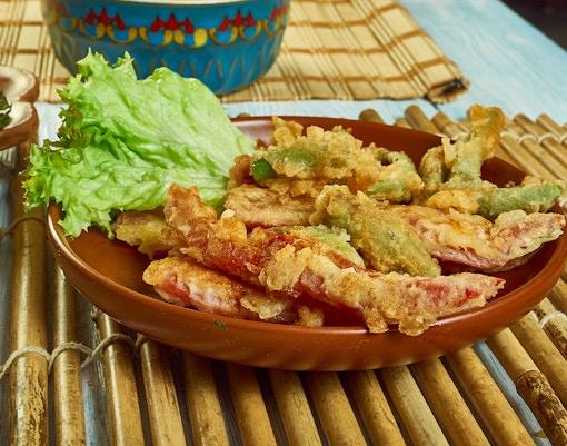 Portuguese Peixinhos da horta on a plate with lettuce, showcasing traditional fried green beans.