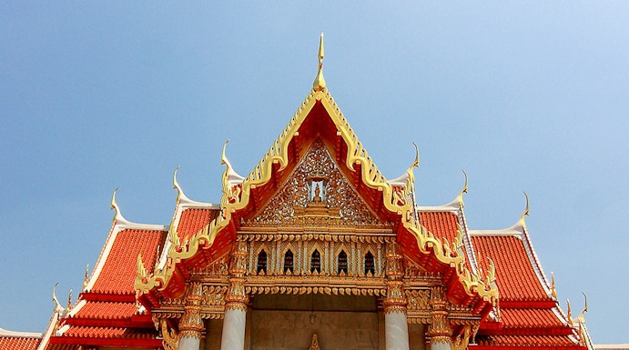 Wat Benchamabophit temple with ornate roof and lion statues, Bangkok, Thailand.