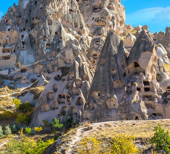 Rock formations with carved caves at Goreme Open Air Museum, Cappadocia, Turkey.