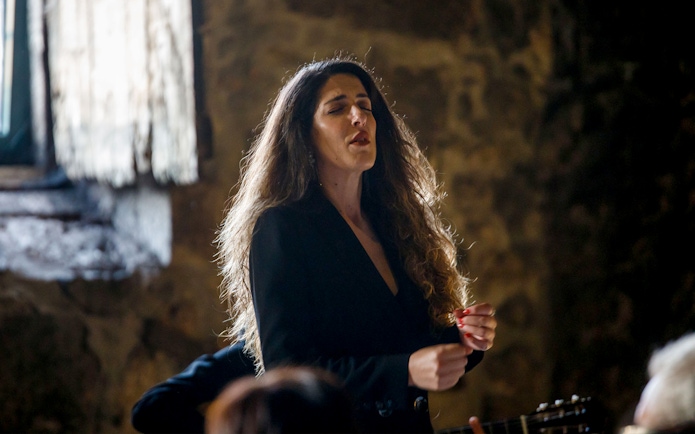 Performer singing at Live Fado Show in Fonseca Port Wine Cellars.