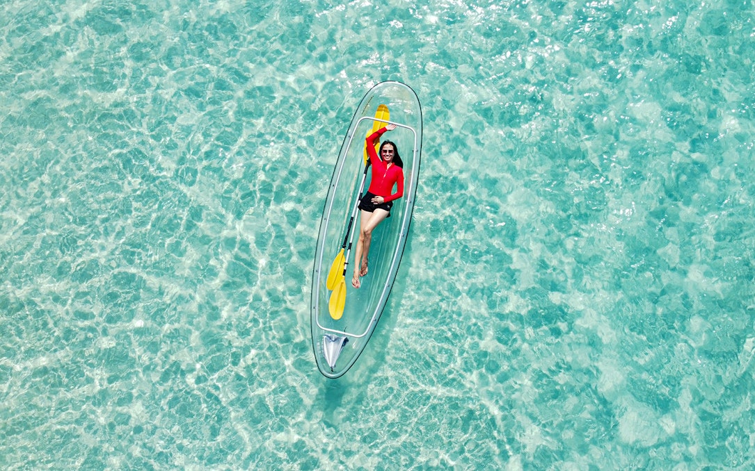 Person kayaking in clear waters during Pattaya Island day trip, Thailand.