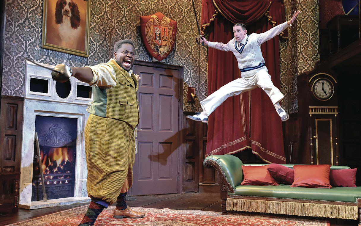 Actors performing a comedic scene in "The Play That Goes Wrong" on stage.