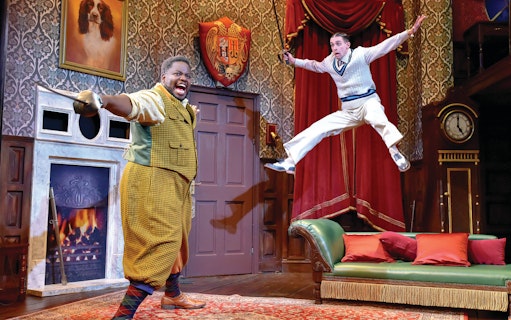 Actors performing a comedic scene in "The Play That Goes Wrong" on stage.