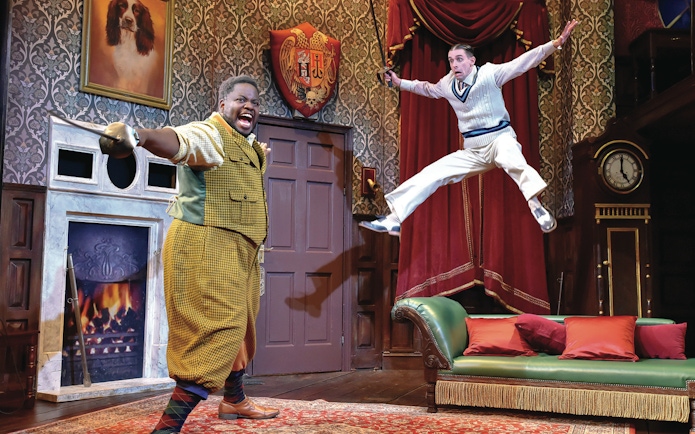 Actors performing a comedic scene in "The Play That Goes Wrong" on stage.