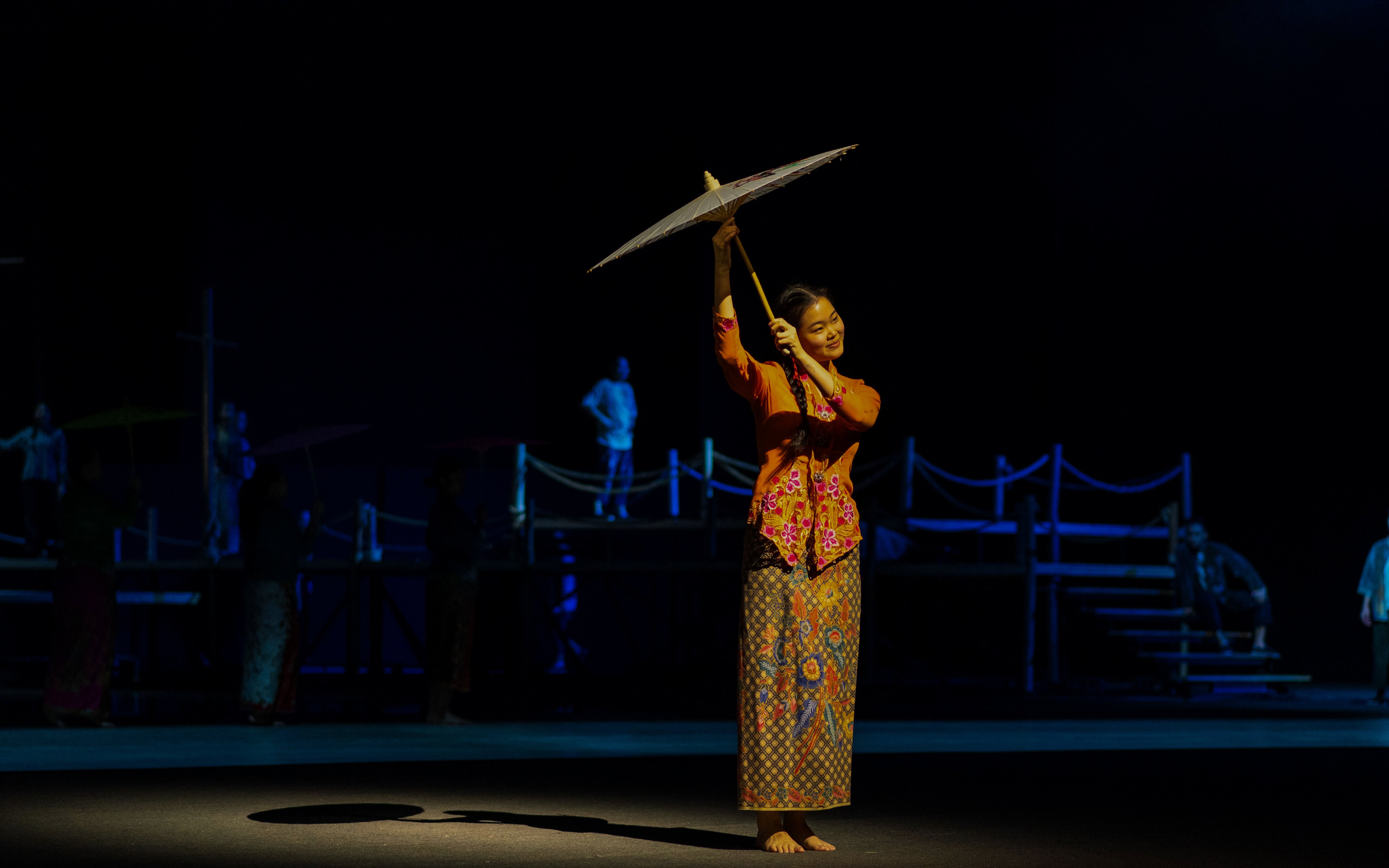 Performer with umbrella at The Legacy of a Generation Show.