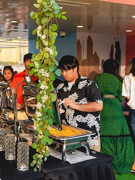 Buffet dinner setup on a sunset cruise in Dubai Marina.