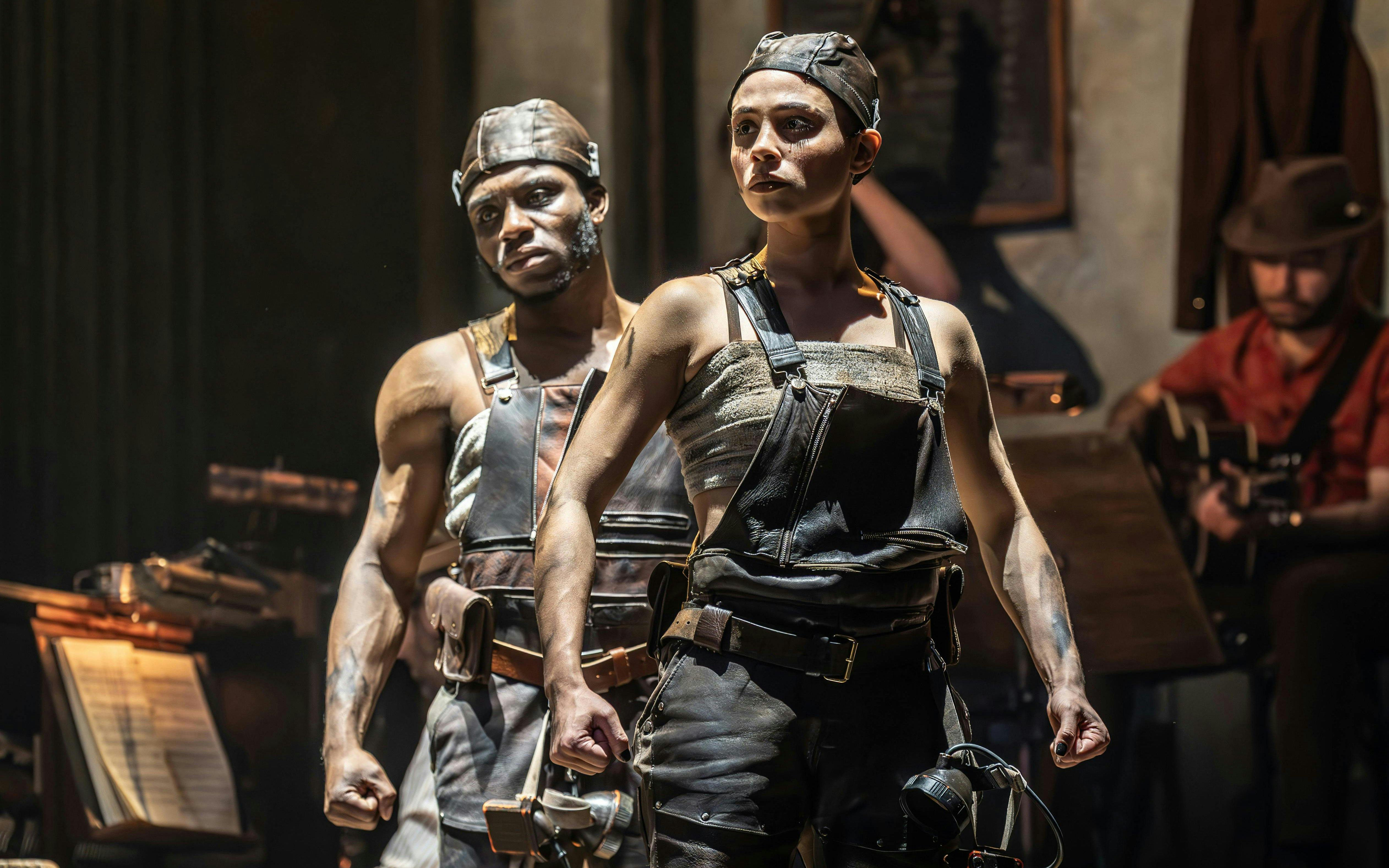 Performers in Hadestown musical on West End stage.