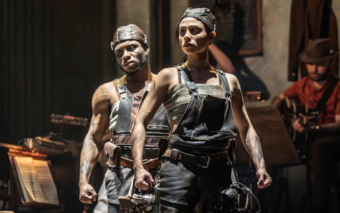 Performers in Hadestown musical on West End stage.