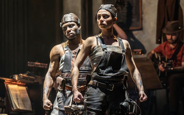 Performers in Hadestown musical on West End stage.