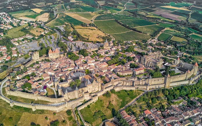 Aerial view of Carcassonne Castle and surrounding landscape in France.