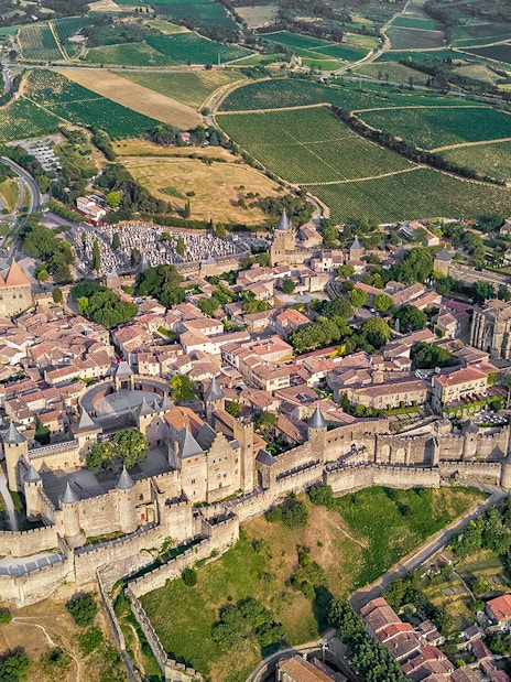Aerial view of Carcassonne Castle and surrounding landscape in France.