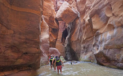 Tourists hiking through Wadi Mujib gorge in Jordan.