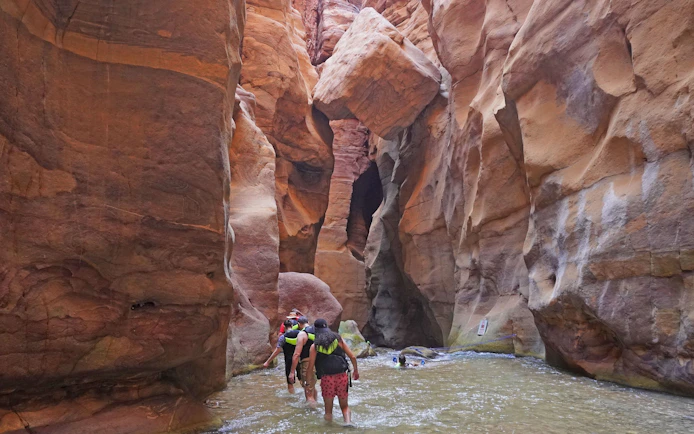 Tourists hiking through Wadi Mujib gorge in Jordan.