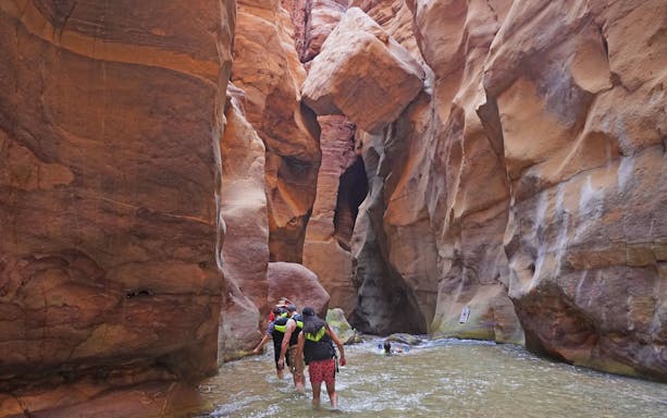 Tourists hiking through Wadi Mujib gorge in Jordan.
