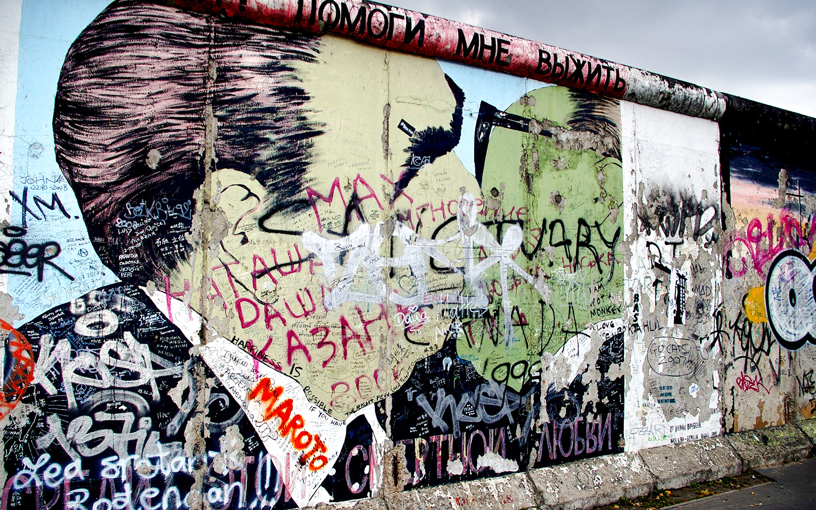 Berlin Wall graffiti art with colorful murals and messages, Berlin