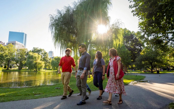 Tourists walking with guide in Boston Public Garden on History & Highlights Discovery Tour.