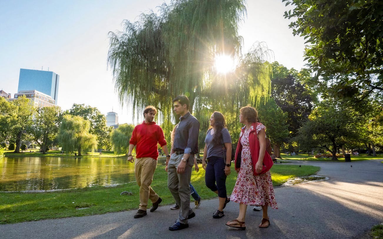 Tourists walking with guide in Boston Public Garden on History & Highlights Discovery Tour.