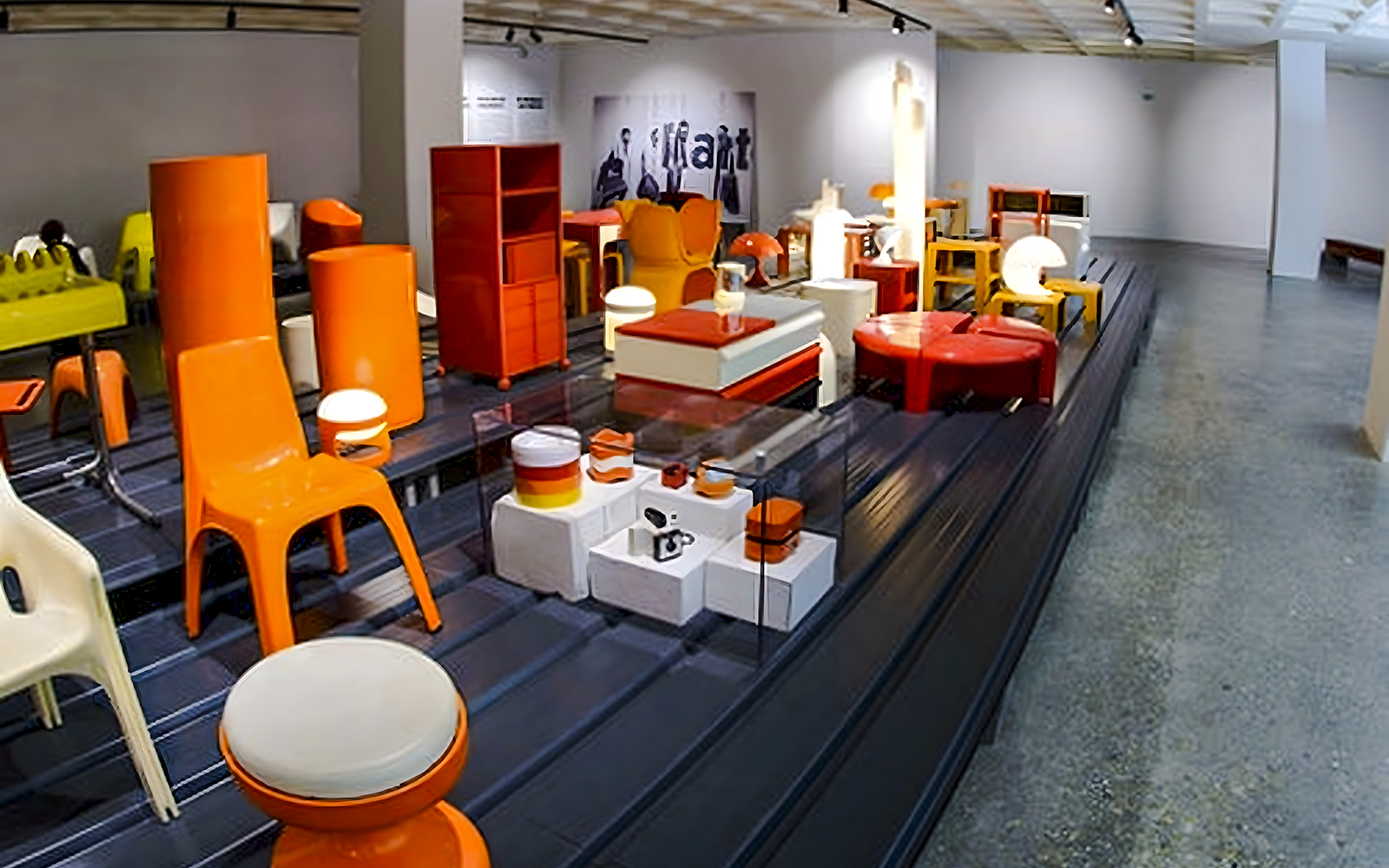 Modern furniture exhibit at Design Museum, Brussels featuring colorful chairs and tables.