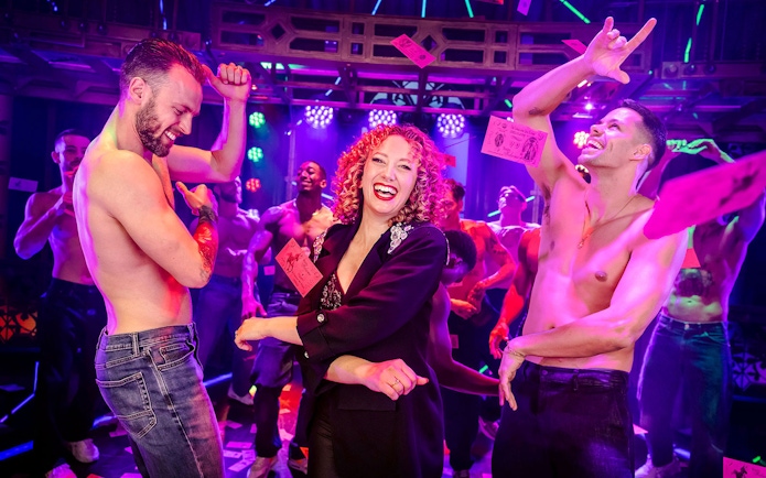 Performers dancing on stage during Magic Mike Live show.