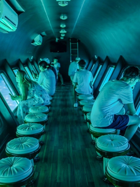 Tourists inside the Royal Seascope semi-submarine viewing the Red Sea, Hurghada.