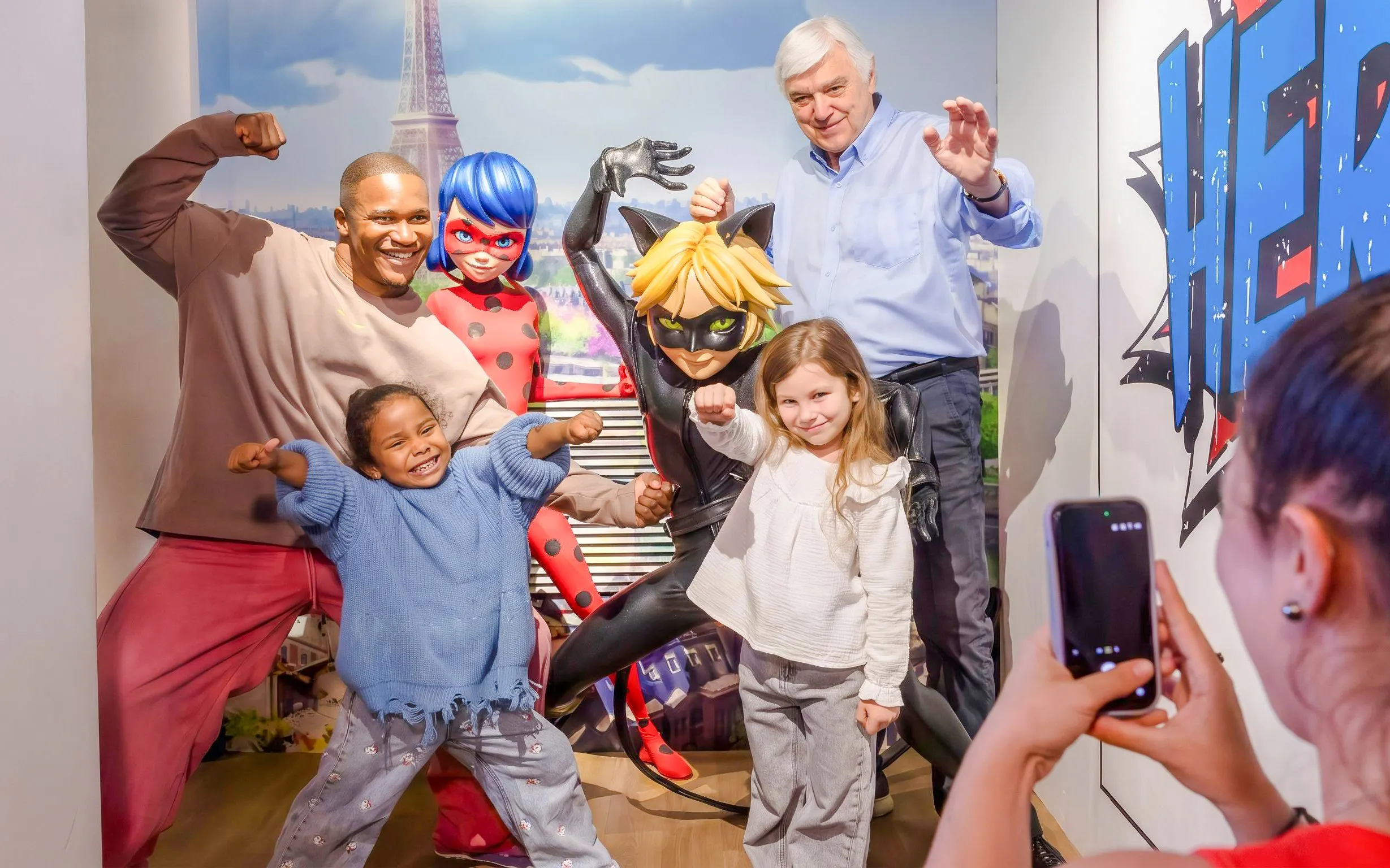Visitors posing with superhero wax figures at Grévin Paris Wax Museum.