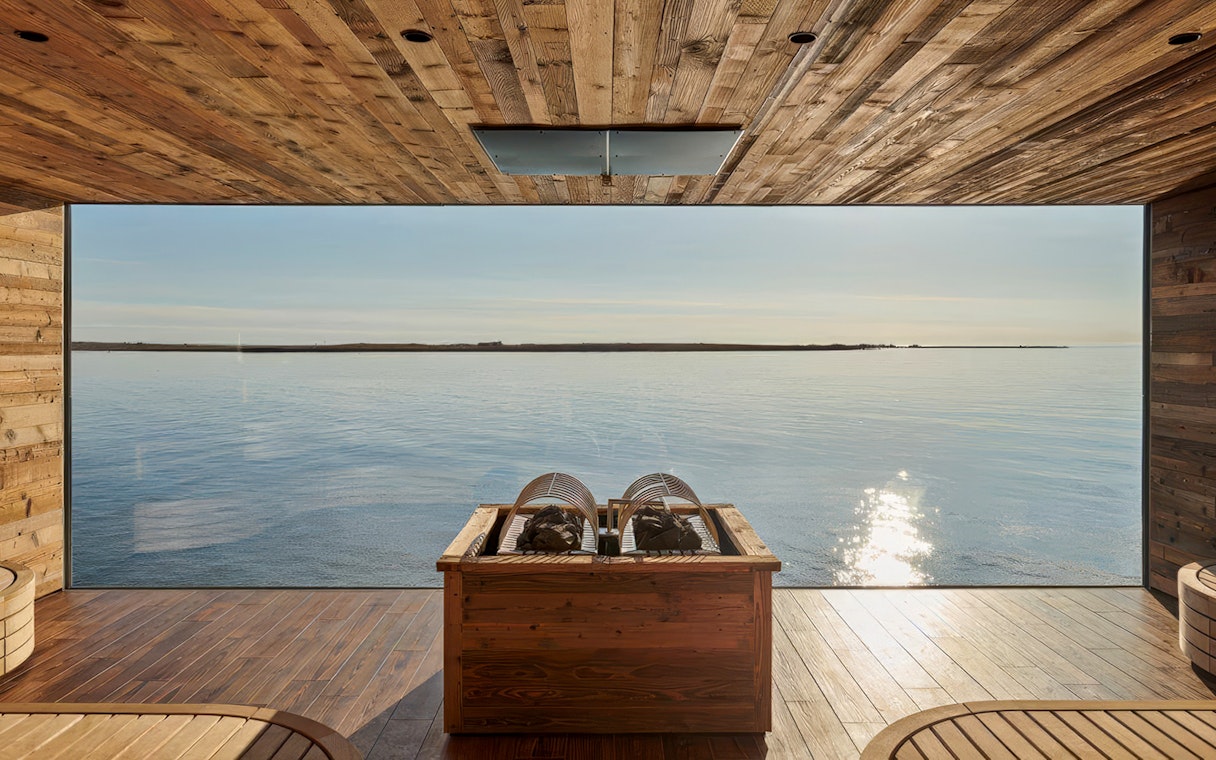 View of the ocean from inside Sky Lagoon with wooden interior.