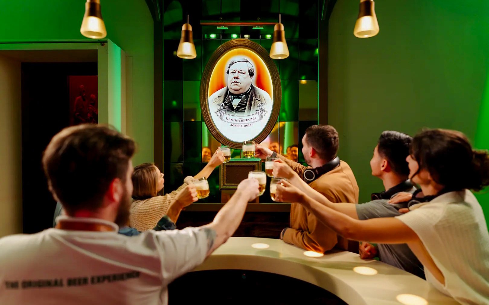 Visitors toasting with beer at the Pilsner Urquell Experience in Prague.