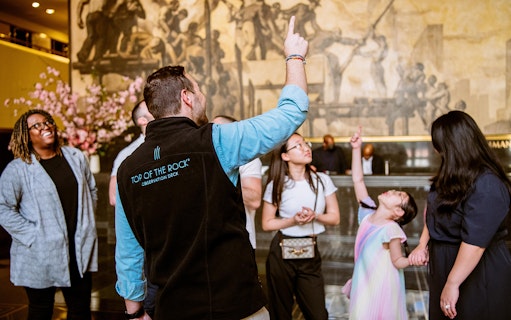 Tour guide leading a group at Rockefeller Center, New York City.