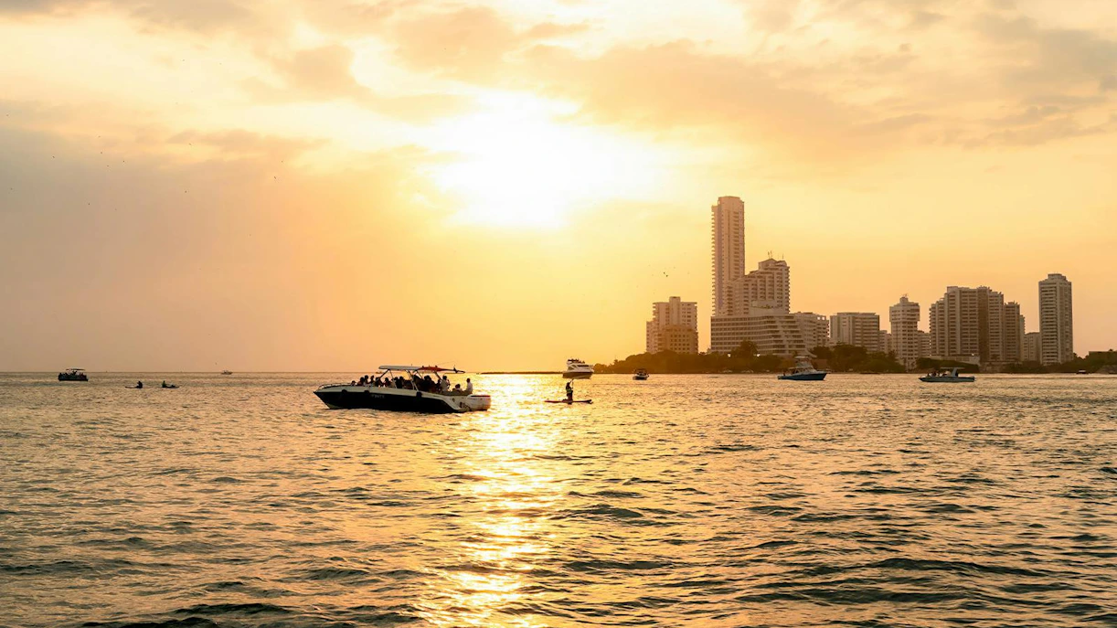 Sunset over Cartagena skyline with boats on the water, Colombia.