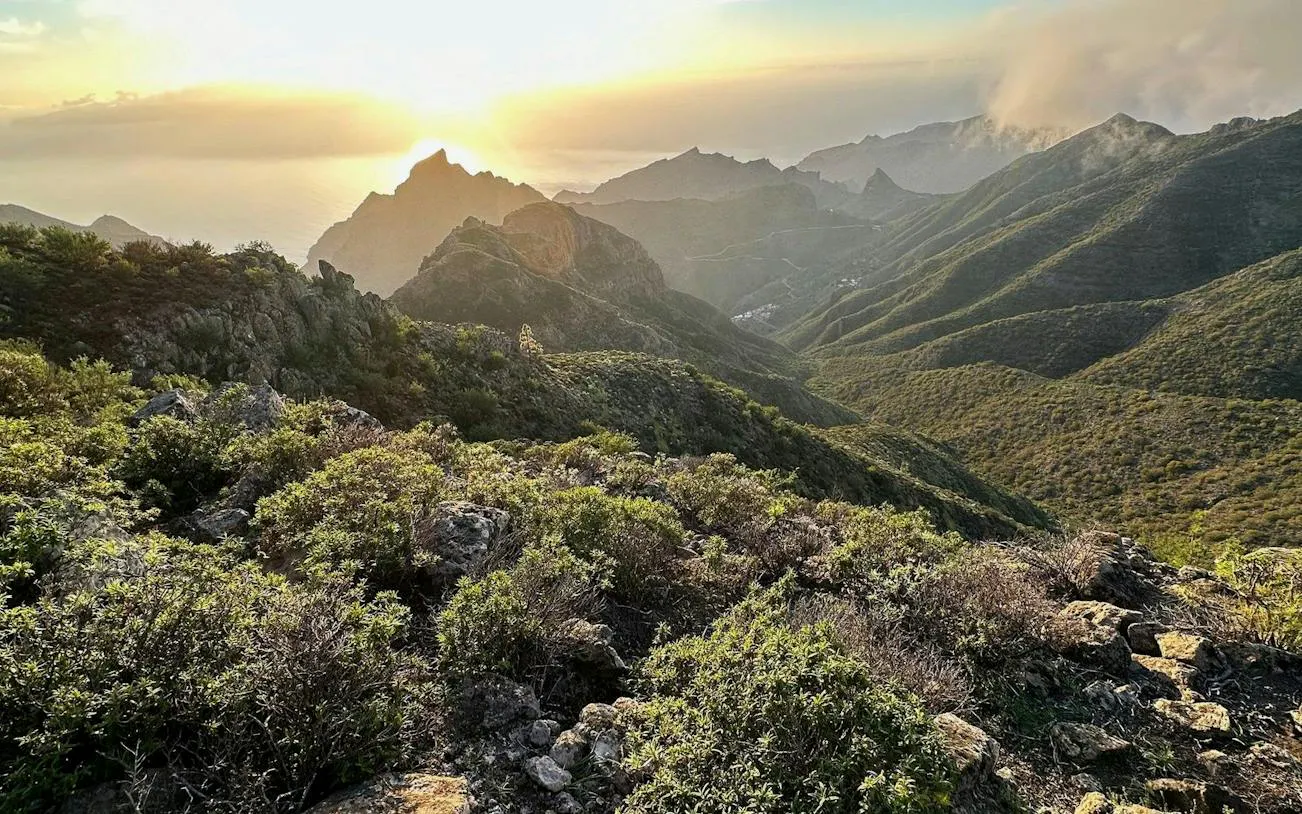 Sunset view over Masca Village and Teide National Park, Tenerife, with rugged mountain landscape.
