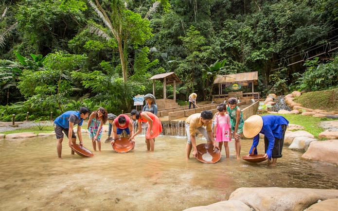 Visitors panning for gold at Sunway Lagoon Theme Park, Malaysia.