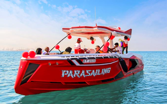 Parasailing boat with passengers on Dubai waters.